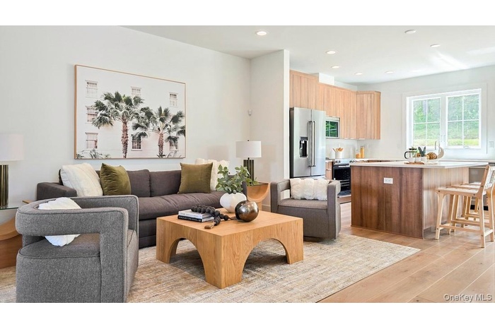 Living area featuring light wood-style flooring and recessed lighting