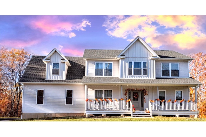 View of front facade with roof with shingles and a porch
