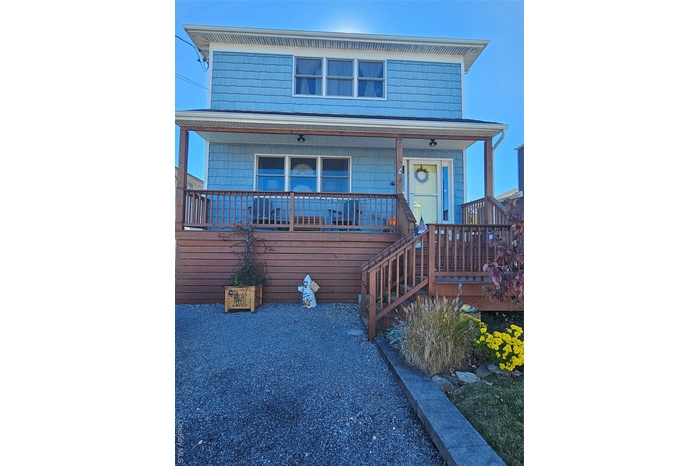 View of front of property with a deck and stairway