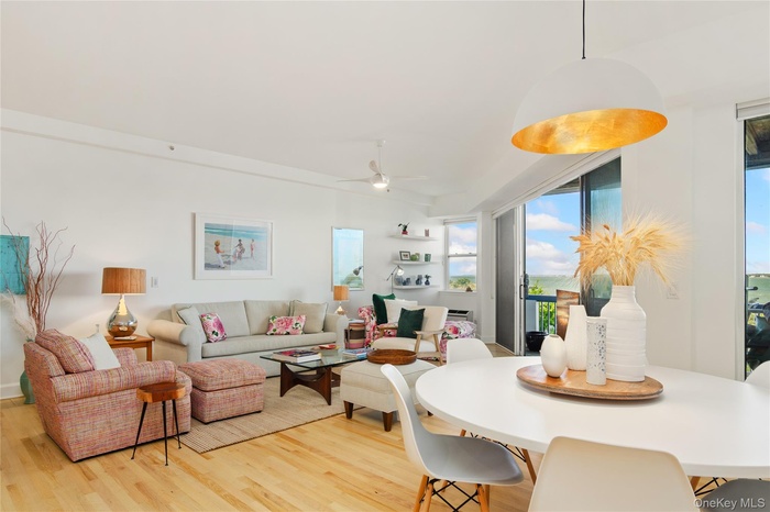 Dining area with light wood-style flooring and ceiling fan