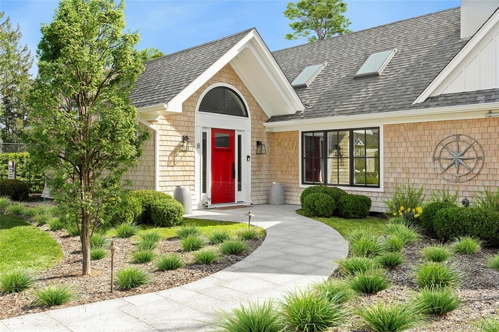 Doorway to property featuring a shingled roof