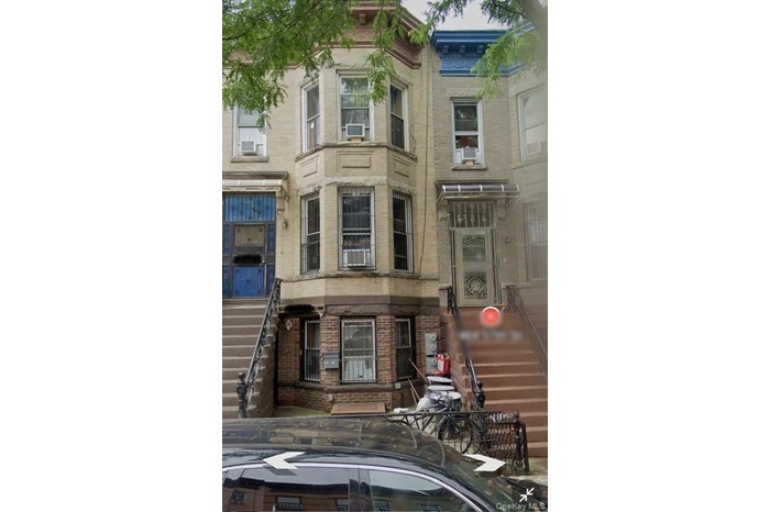 View of property featuring stairs