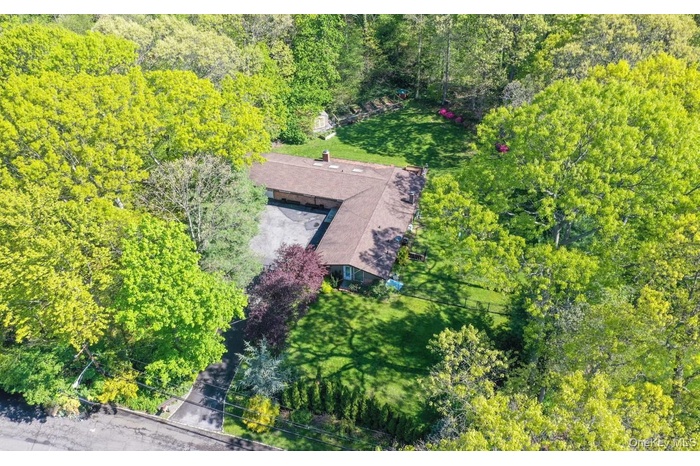 View of subject property with a heavily wooded area