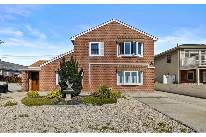 Rear view of property featuring brick siding