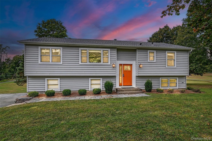 Raised ranch featuring a lawn