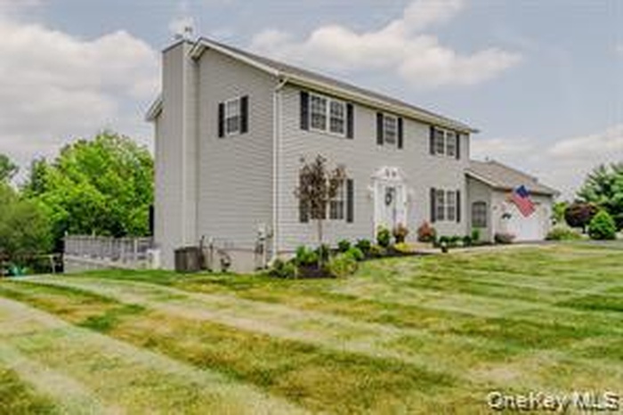 Colonial home with a front yard