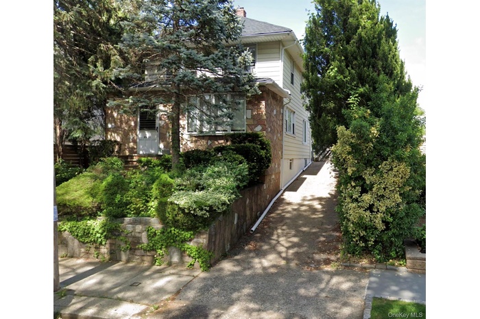 View of side of home featuring stone siding