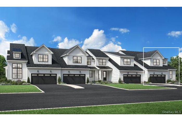 Modern farmhouse featuring asphalt driveway, an attached garage, and a front lawn