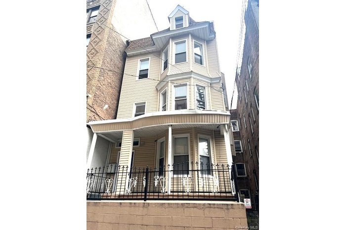 Victorian-style house featuring covered porch