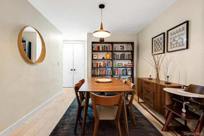 Dining space featuring light wood-style floors and baseboards
