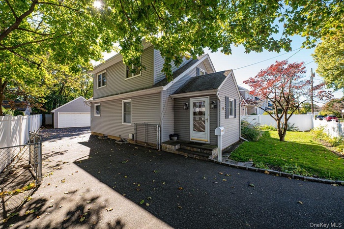 View of front of home featuring a 2 car detached garage,
