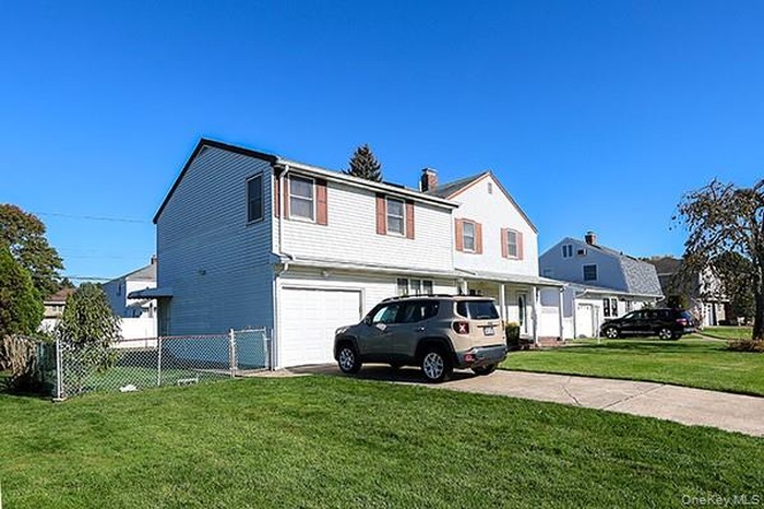 Traditional home with a garage and driveway