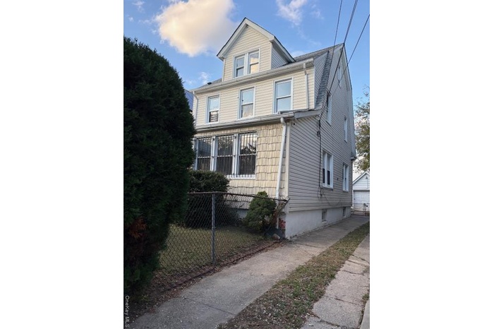 View of front of property with a detached garage