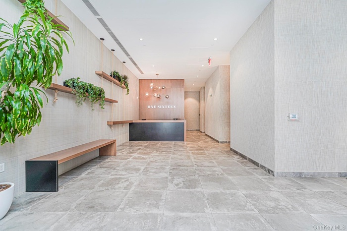 Welcome area with a chandelier and recessed lighting
