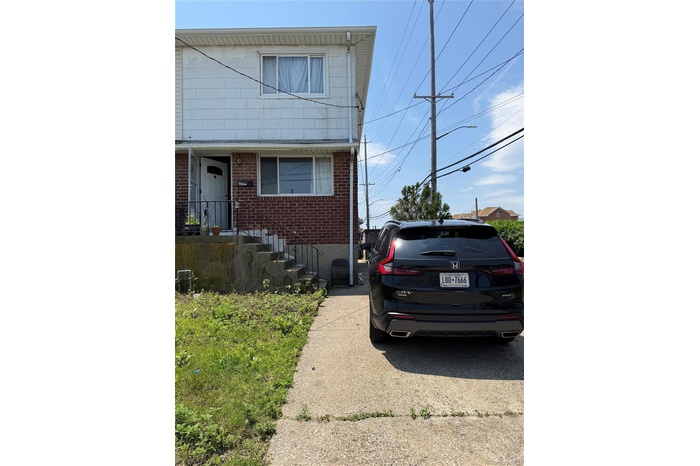 View of front of home featuring brick siding