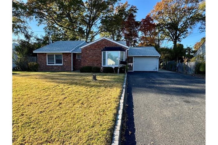 Single story home with brick siding and private driveway.