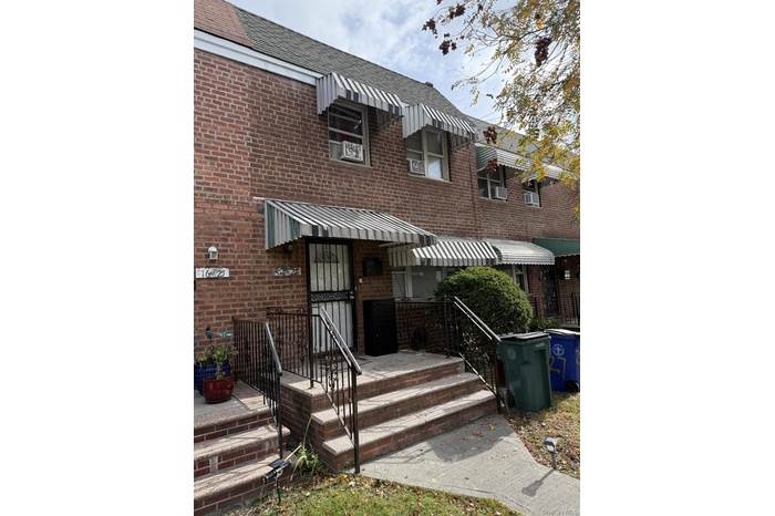 Rear view of house featuring brick siding