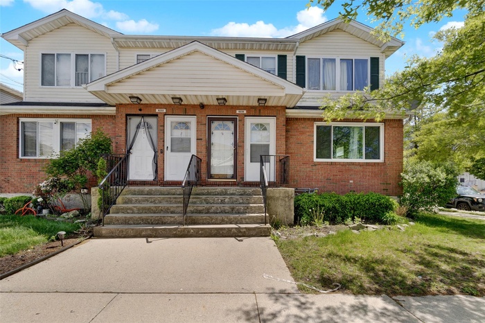 Townhome / multi-family property with brick siding
