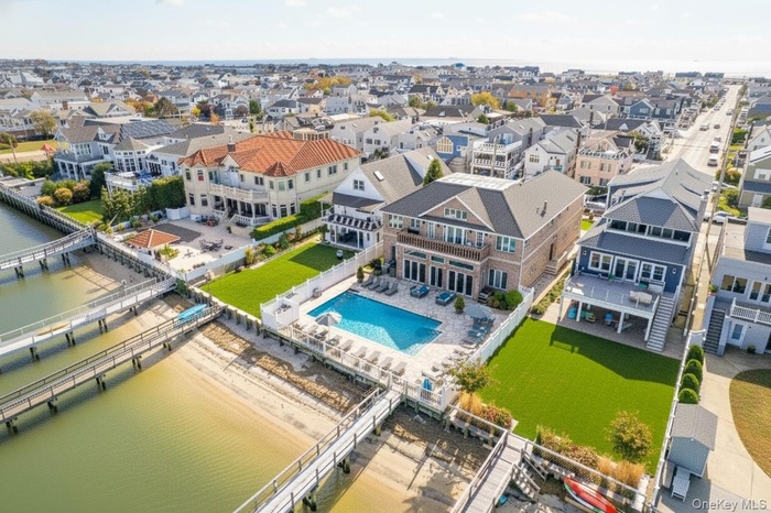 Aerial view of residential area with a pool area and a nearby body of water
