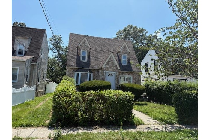 Cape cod home with stone siding
