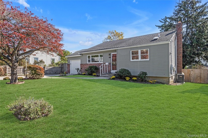 Split Ranch featuring vinyl siding and attached garage