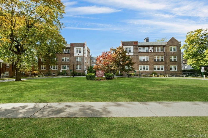 View of home's community featuring a lawn and volleyball court