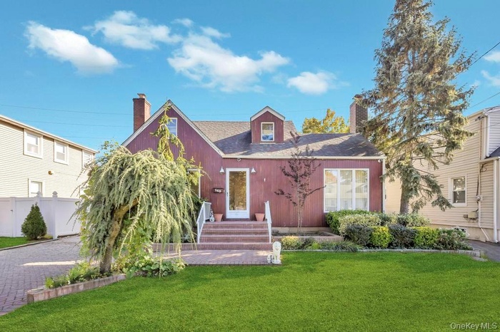 Cape cod house with a chimney and roof with shingles
