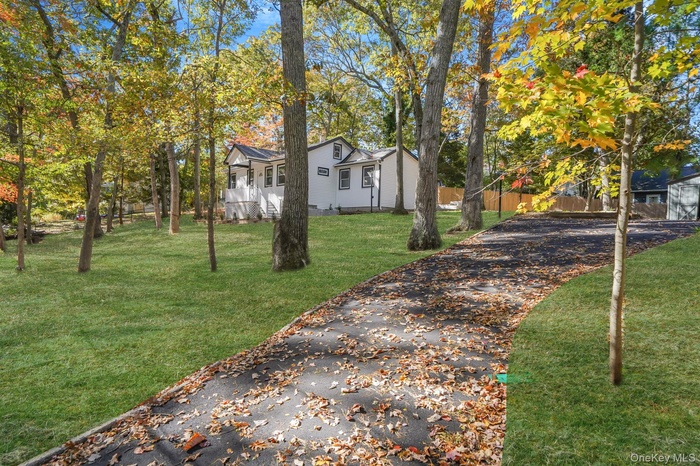 View of yard featuring driveway . *grass is photoshopped*
