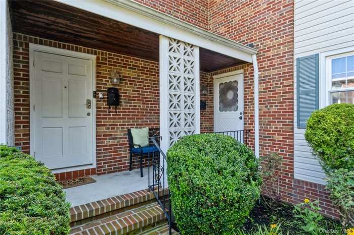 Entrance to property featuring brick siding
