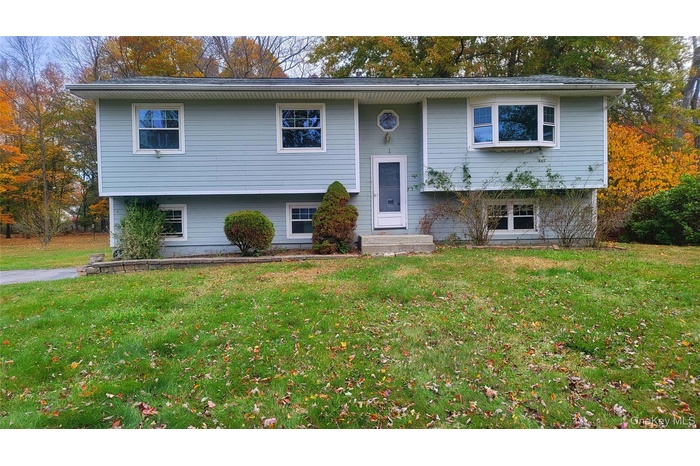 Split foyer home with a front yard