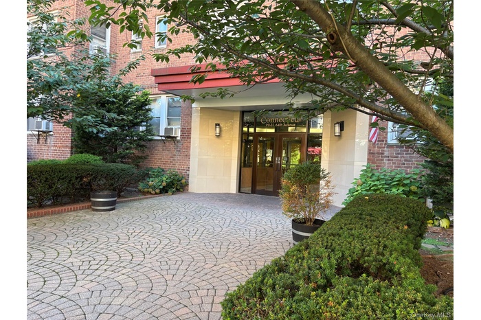 View of exterior entry featuring french doors and brick siding