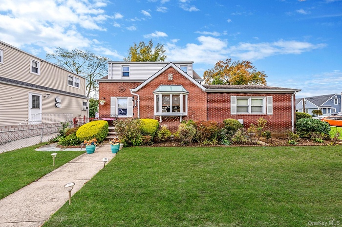 View of front of home featuring brick siding