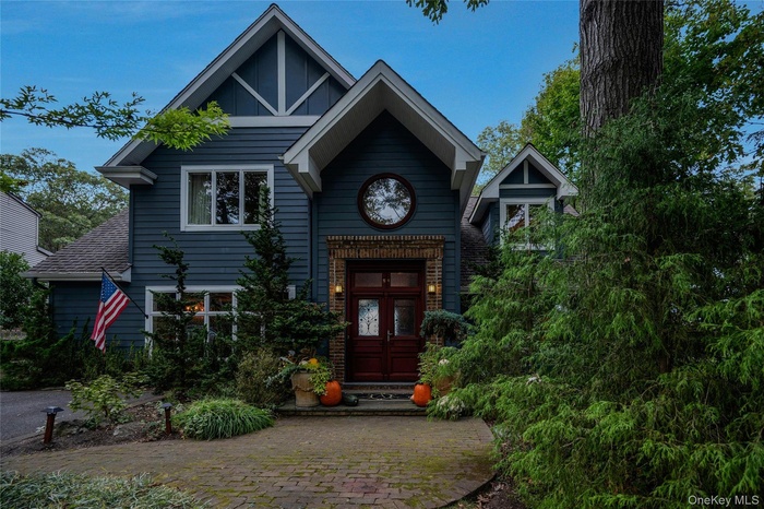 View of front of property with a shingled roof
