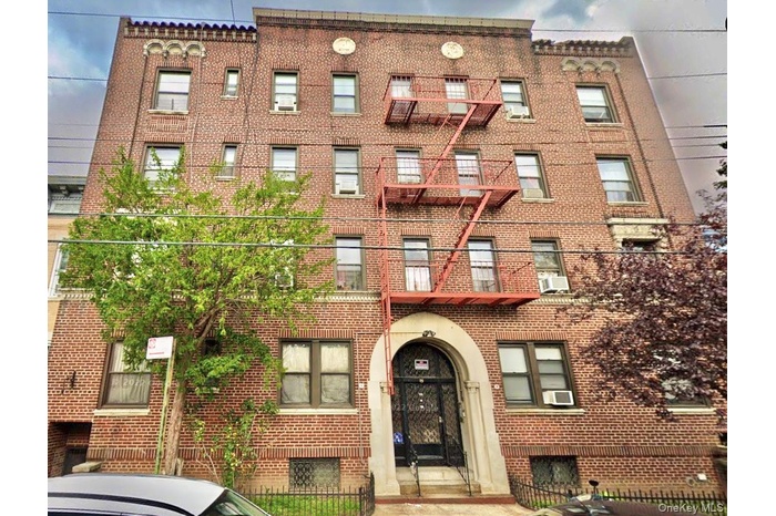 View of apartment building / complex featuring a fenced front yard