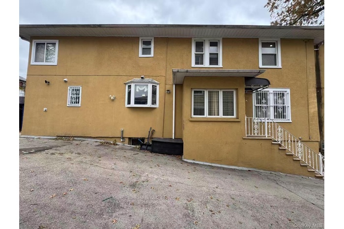 Back of house featuring stucco siding
