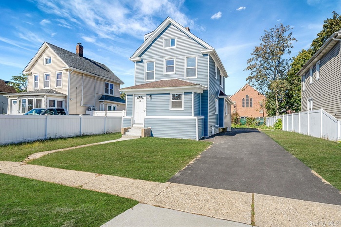 View of front of home featuring driveway and entry steps