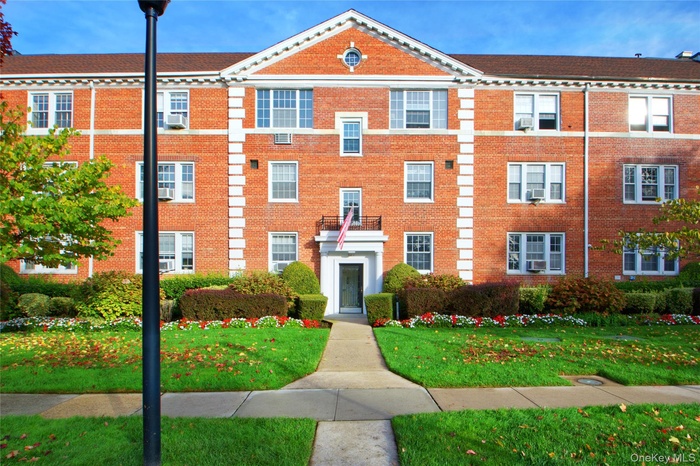 View of front of house with brick siding and a front yard