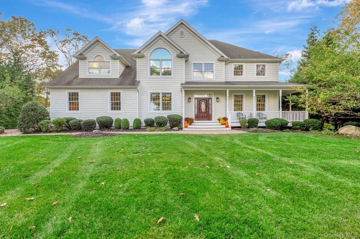 View of front of home featuring a porch, a front lawn, and roof with shingles