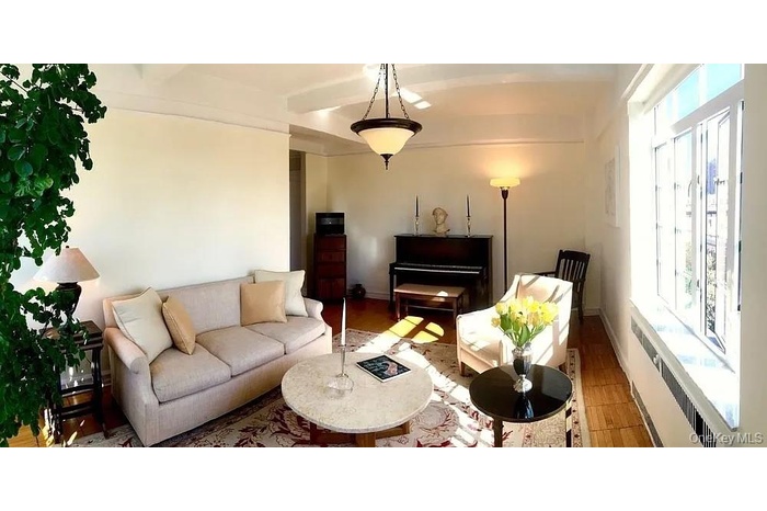 Living area with radiator heating unit and wood finished floors