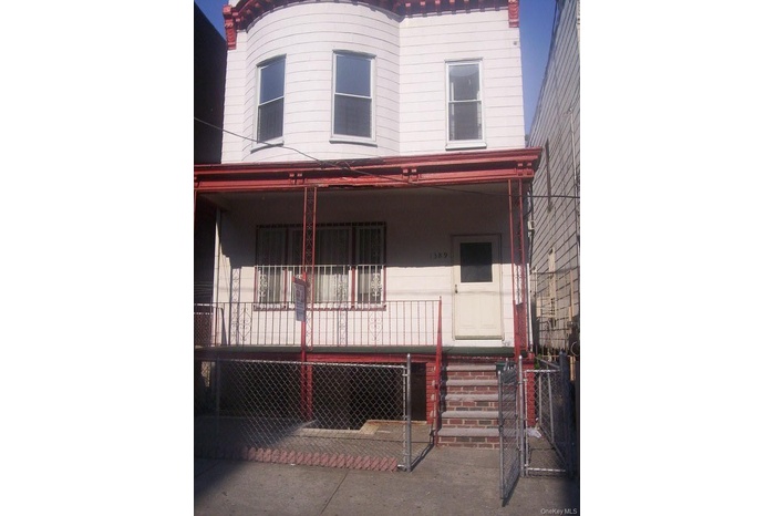 Italianate home with a gate and a porch