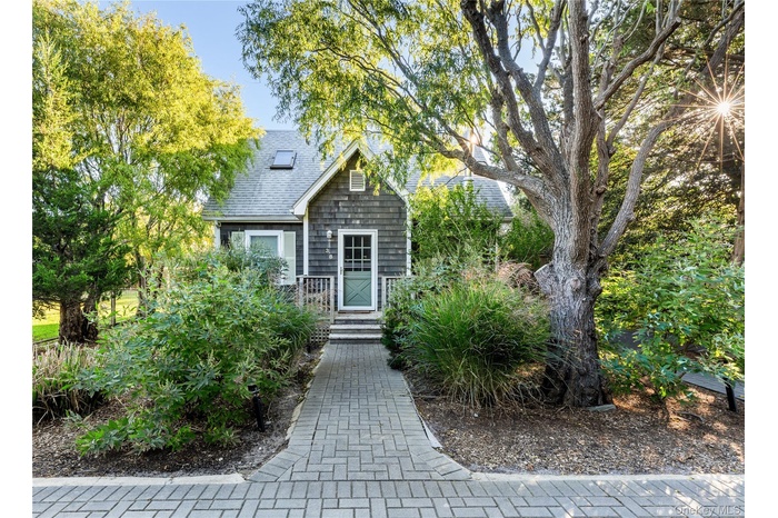 Entrance to property featuring roof with shingles