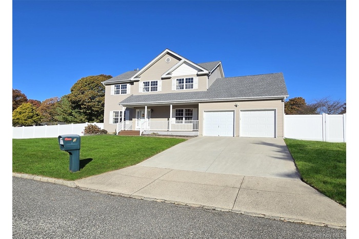 View of front of home featuring a porch, driveway, a garage, and a shingled roof