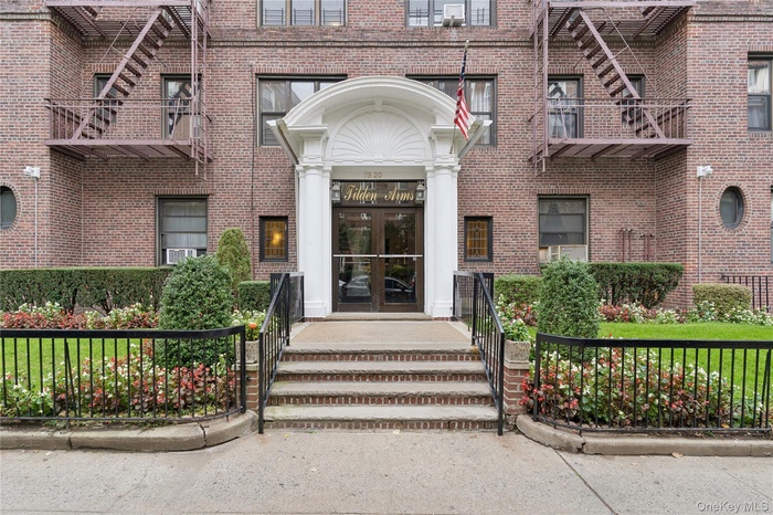 Doorway to property featuring french doors and brick siding