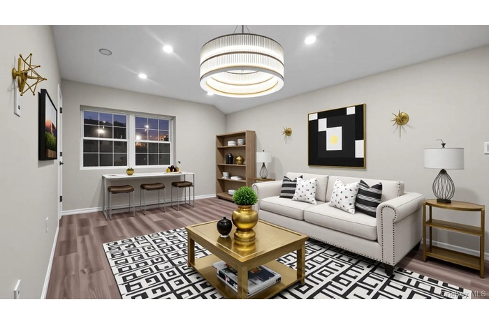 Living room with recessed lighting, dark wood-type flooring, and a chandelier