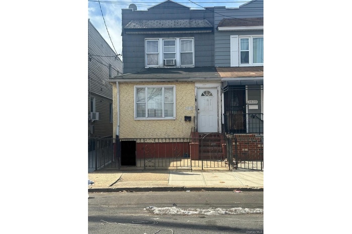 Traditional home with a fenced front yard, a gate, and cooling unit