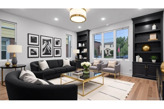 Living room featuring built in shelves, light wood finished floors, and recessed lighting