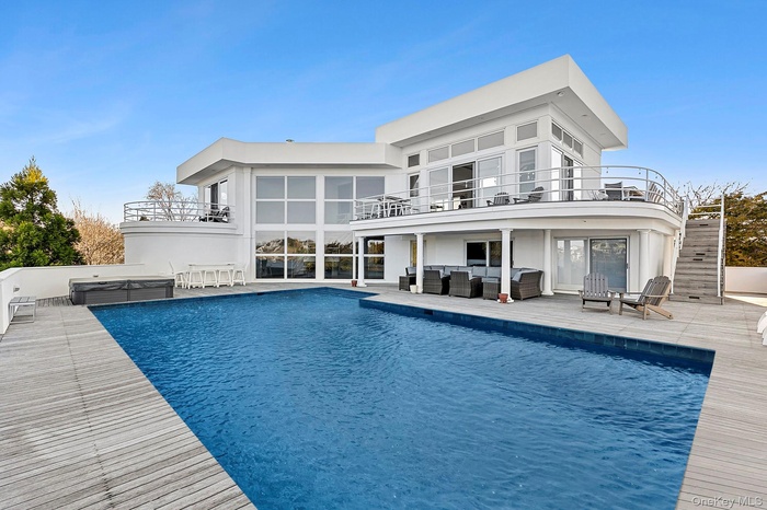 Rear view of house with stairs, outdoor lounge area, a patio area, and a balcony