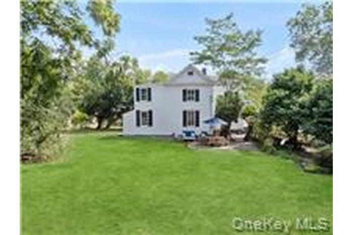 Back of property featuring a lawn