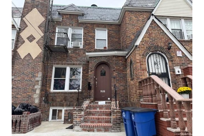 Tudor home with brick siding and a high end roof