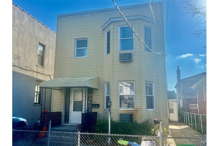 Traditional home with a fenced front yard and a gate